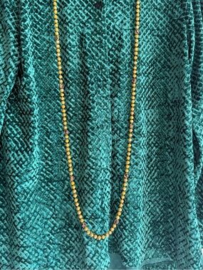 Long Gold Bead Necklace with Decorative Accents